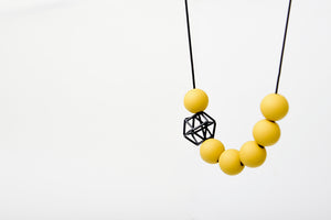 Dijon-hued Acrylic Balls Punctuated By Black Hexagon